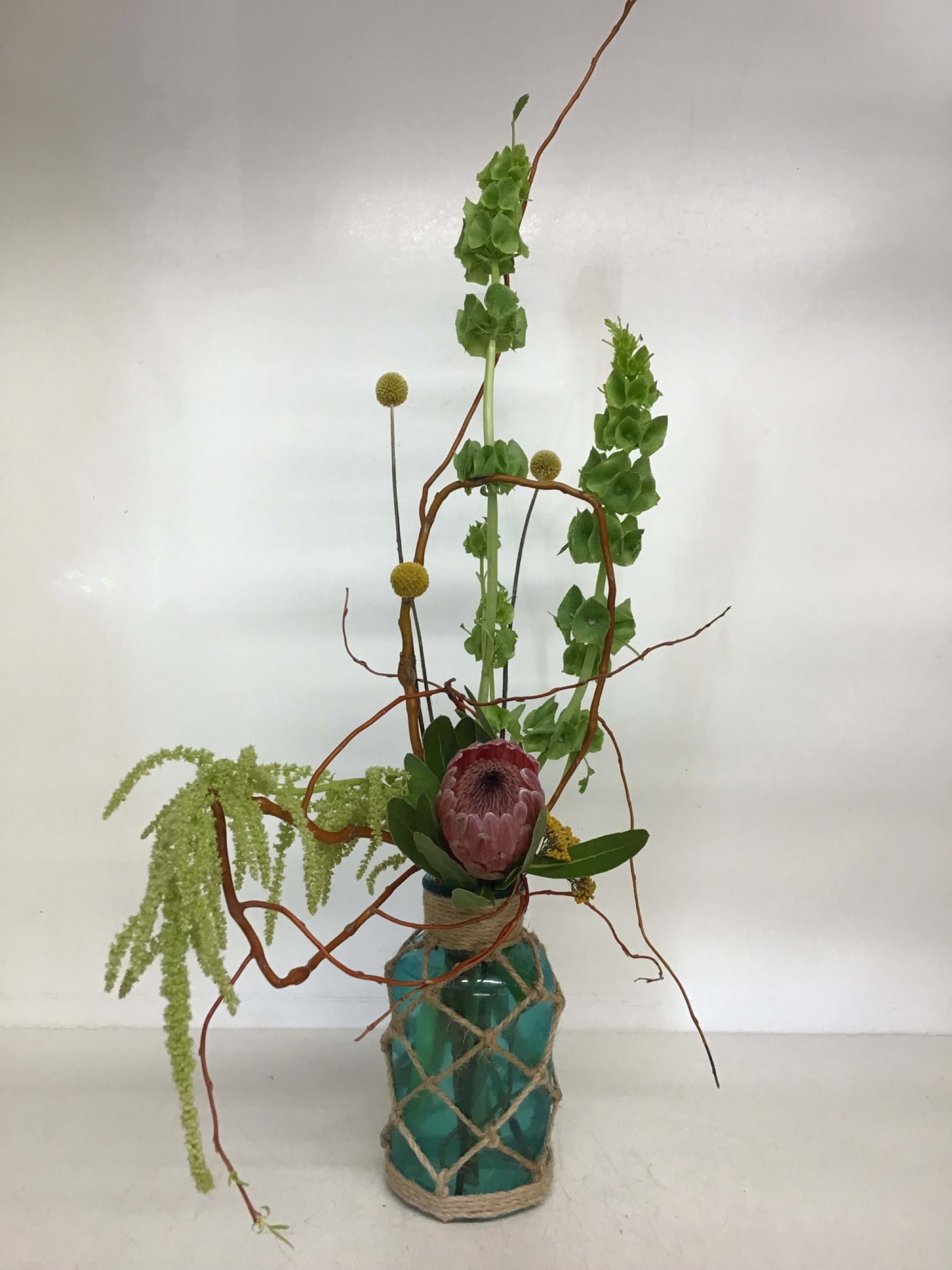 Protea — bells of ireland arrangement, hand-composed in The Flower Lover atelier in Huntington Beach